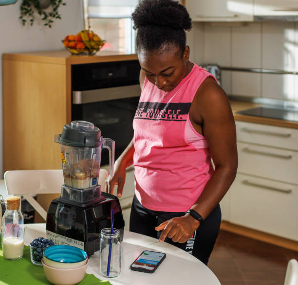 istock A Black Woman Makes Protein Shake In Blender 1582579513