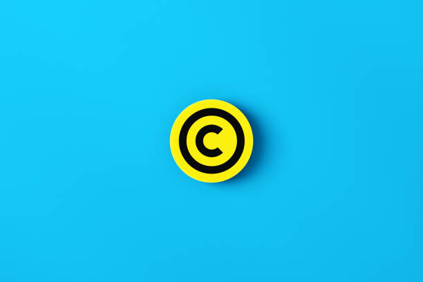 Intellectual property rights concept. Copyright symbol on a yellow round button on blue background.