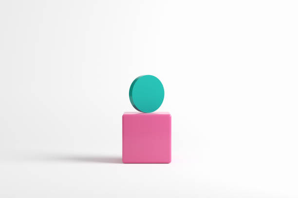 istock Green cylinder on top of a pink cube on white background. 1582581140