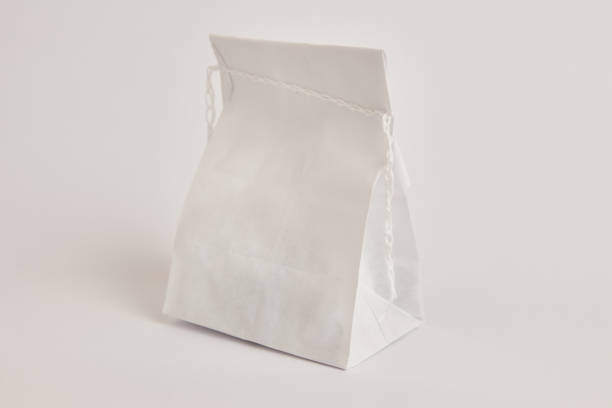 istock Paper bag with coffee beans, sewn with thread. Dry food packaging. 1582583889