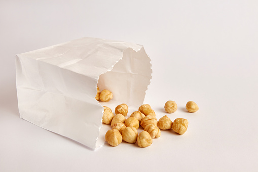 Two plastic bags with packed peanuts on a light gray background.
