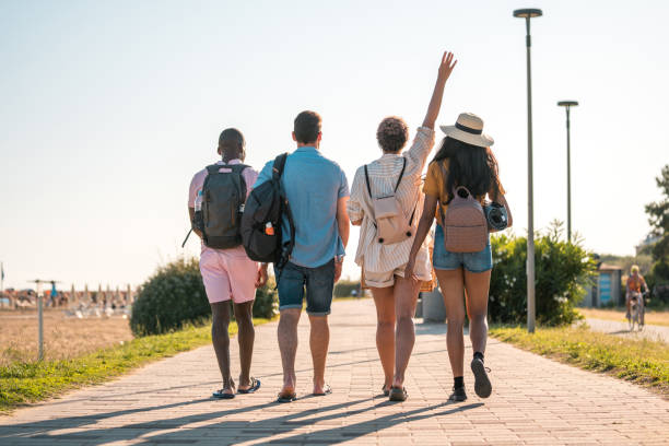 istock Cheerful Young Mixed Race Friends Walking To The Beach 1582602802