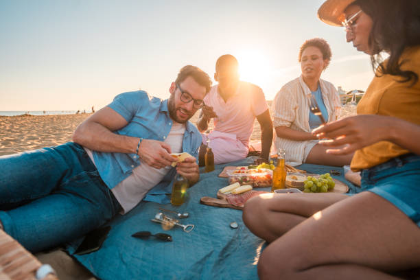 istock Beach Picnic Celebration With Multiracial Friends 1582604916