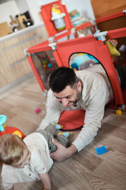 istock Play Chase While Crawling By Father And Baby Son 1582627322