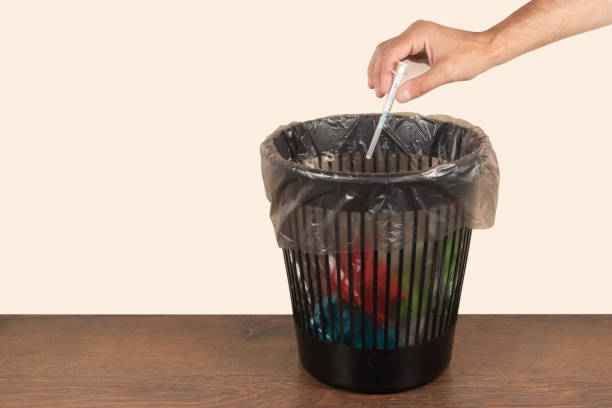istock Throw medicine trash bottom view expired pills syringe addiction problem modern world 1582646482