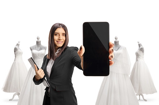 Bridal shopt assistant showing a smartphone isolated on white background