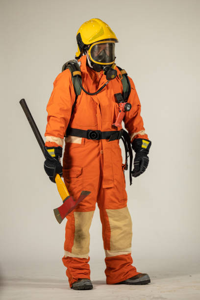 istock Firefighters wearing helmets with fire safety equipment Use Twirl aerosol fire extinguishers to fight oil flames.Preventing fire accidents is an industrial safety concept. 1582657747