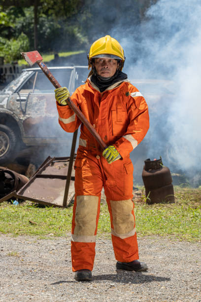 istock Firefighters wearing helmets with fire safety equipment Use Twirl aerosol fire extinguishers to fight oil flames.Preventing fire accidents is an industrial safety concept. 1582659896