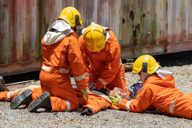 istock Firefighters wearing helmets with fire safety equipment Use Twirl aerosol fire extinguishers to fight oil flames.Preventing fire accidents is an industrial safety concept. 1582663162
