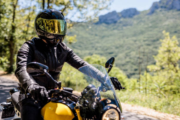 istock Man rides motorbike 1582665431
