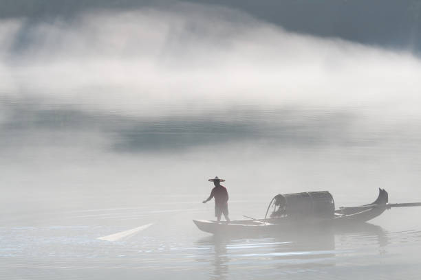 istock fishermen in the fog preparing to fish 158267522