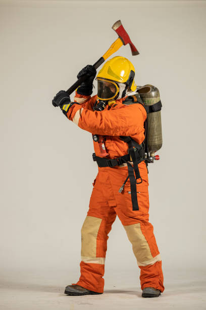 istock Firefighters wearing helmets with fire safety equipment Use Twirl aerosol fire extinguishers to fight oil flames.Preventing fire accidents is an industrial safety concept. 1582678935