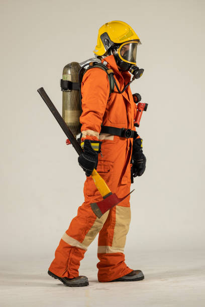 istock Firefighters wearing helmets with fire safety equipment Use Twirl aerosol fire extinguishers to fight oil flames.Preventing fire accidents is an industrial safety concept. 1582679022