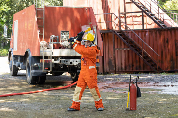 istock Firefighters wearing helmets with fire safety equipment Use Twirl aerosol fire extinguishers to fight oil flames.Preventing fire accidents is an industrial safety concept. 1582680621