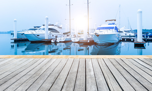Background of pier with yachts and wood platform