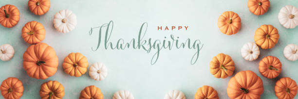 Autumn happy thanksgiving banner background. Decorative orange and white pumpkins on blue table top view. stock photo