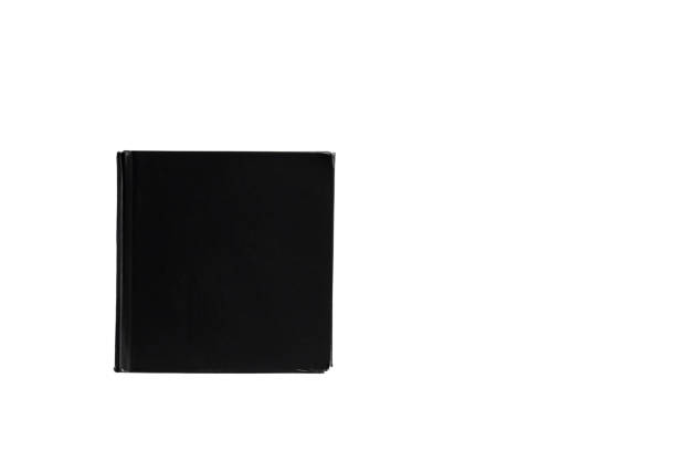 istock The image shows a black thick hardcover book lying vertically on a white background. 1582689812