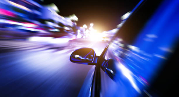 istock Night drive with motion blur city background 1582689892