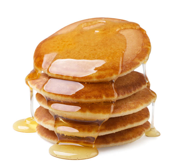 istock Pancakes poured with honey on a white background. Isolated 1582694303