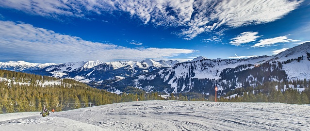 Panoramic image of a ski slope in Ifen ski resort in Kleinwalsertal valley in Austria during the daytime