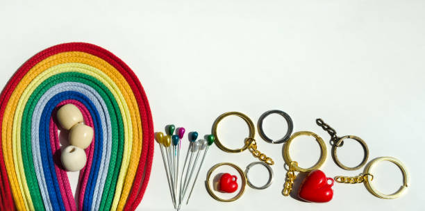 istock Bright rainbow palette of multi-colored cotton threads, hooks and accessories isolated on a white background. 1582698690