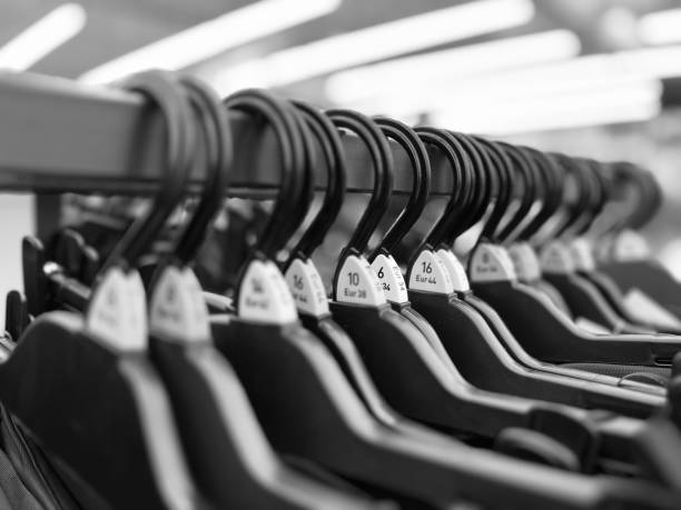 istock Clothes hanging up in a retail store 1582714216