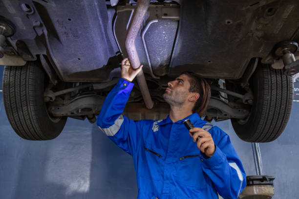 istock A car mechanic is checking items that need replacement parts for a customer who repairs a car at a garage. 1582719628