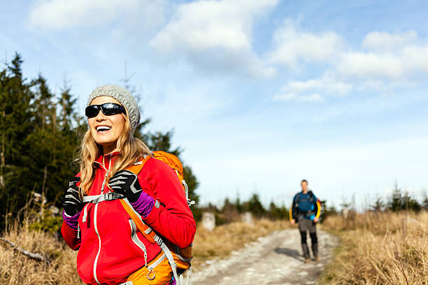 Couple walking and hiking on mountain trail stock photo
