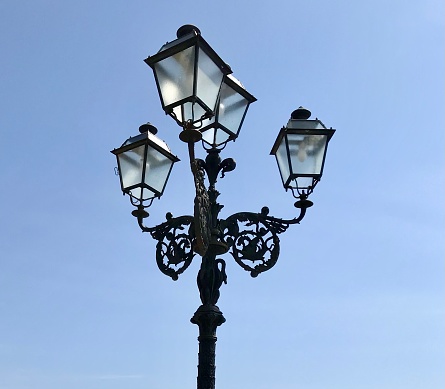 Beautiful black wrought iron 4 lampshade lamppost in a square in Piazza IX Aprile, Taormina, Sicily