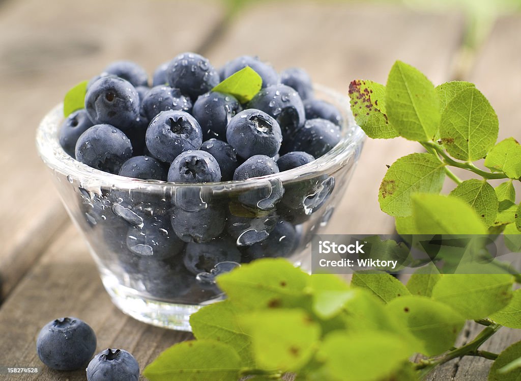 blueberries Wet blueberries in glass bowl, selective focus Berry Fruit Stock Photo