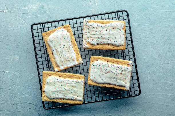 istock Pop tarts on a baking rack. Poptart toaster pastry with icing on blue 1582779590
