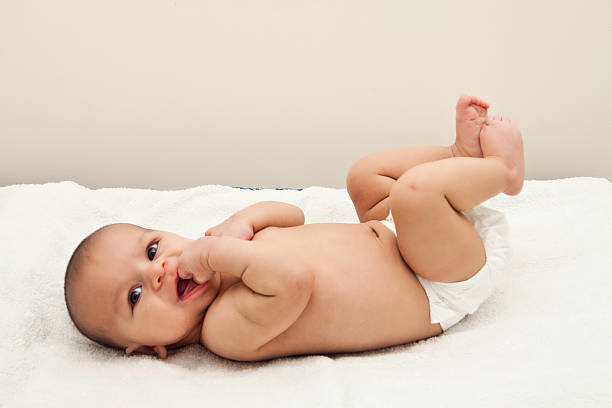 istock newborn baby in nappy smiling 158278289