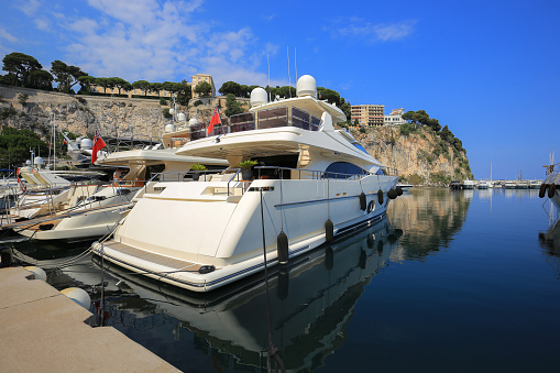 Monaco - 23 yuly, 2019: White luxury yacht moored in the Port de Fontvieille port in Monaco