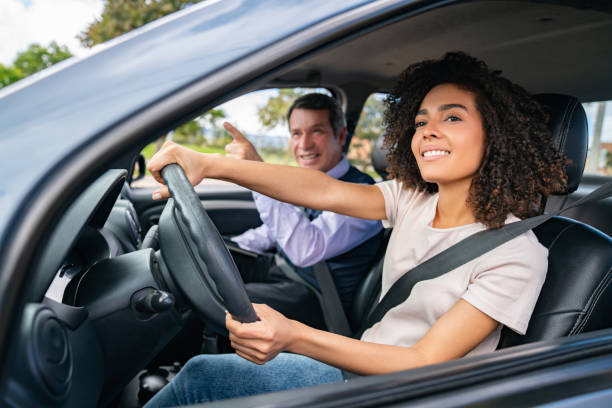 istock Happy woman learning how to drive 1582802921