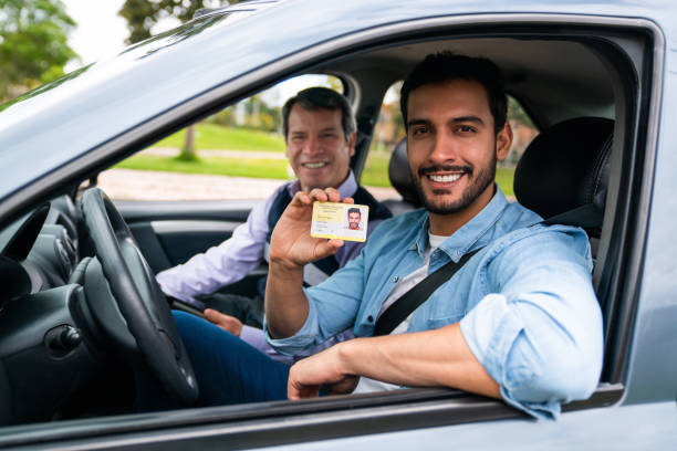 istock Happy man getting his driver's license after approving his driving test 1582802928