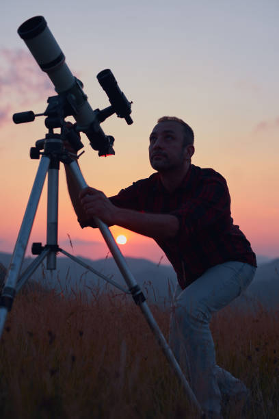 istock Astronomer looking at the skies with a telescope. 1582807154