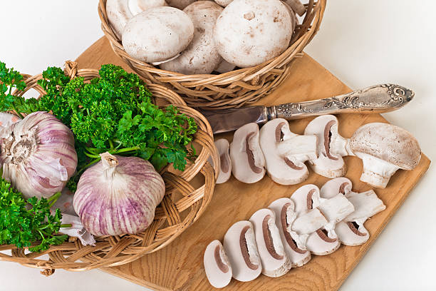 Mushrooms with parsley  on a wooden cutting board stock photo