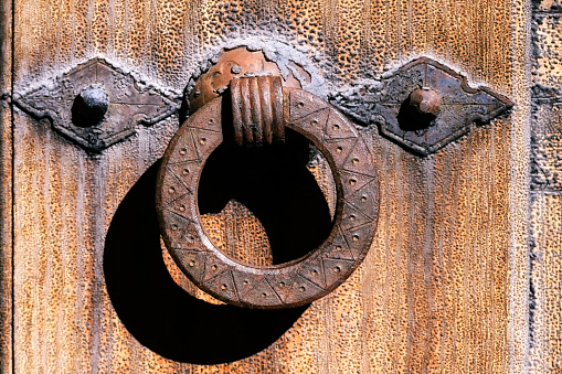 wooden door padlocked with a chain