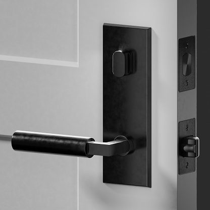 Closeup of black door handle and lock on partially open door three quarter side view