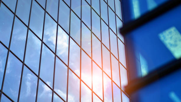 istock Structural glass wall reflecting blue sky. Abstract modern architecture fragment. 1582893139