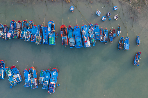 Drone view of fishing boats are nailing side by side on My Tan beach, Ninh Thuan province,  central Vietnam