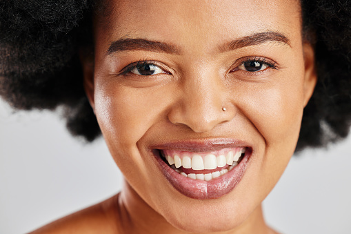 Beauty portrait, dental or African woman smile for studio skincare shine, facial cosmetics or clean teeth whitening. Natural aesthetic makeup, oral tooth care or happy person face on white background