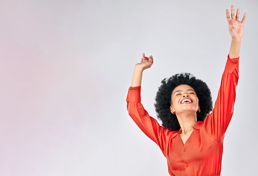 Happy black woman, dance and success in studio for freedom, celebrate party and winning bonus lottery with mockup space. Excited female model, celebration and dancing with energy on white background