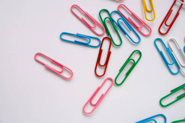 istock Multi colours paper clips isolated on a white background 1582942368