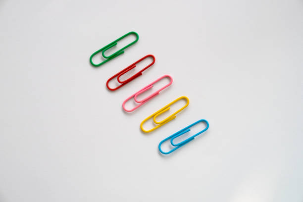 istock Multi colours paper clips isolated on a white background 1582945011