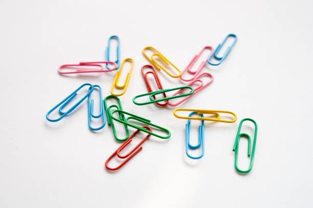 istock Multi colours paper clips isolated on a white background 1582945035