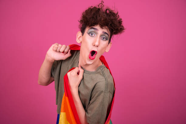 istock Make up. Funny drag queen posing in the studio on a pink background. 1582948627