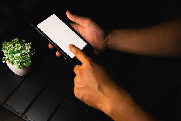 istock person sitting on smartphone 1582949487