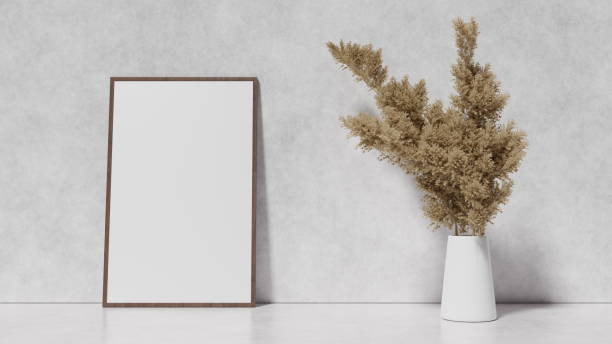 istock Ornamental plant and empty white picture in frame on light wall background, interior design, place for text, frame with a white background layout for design. 3d render 1582949494