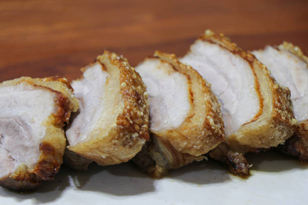 istock Oriental Roast Pork Belly on wooden chopping board 1582977405